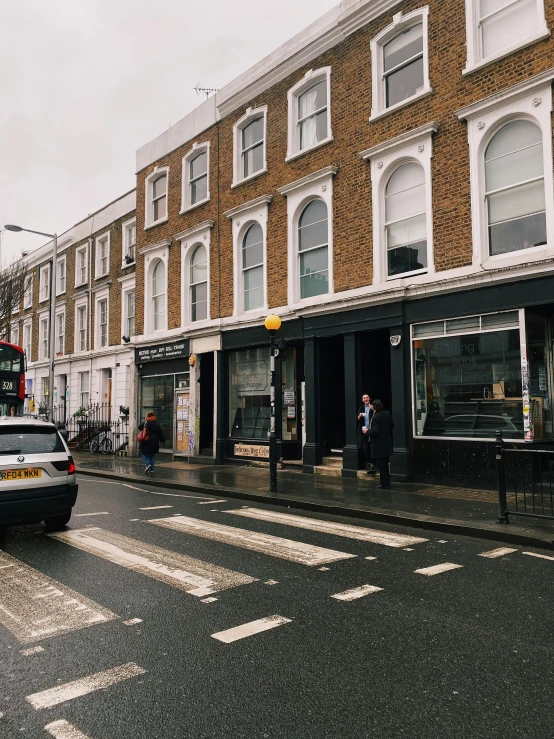 a car is driving down a small street