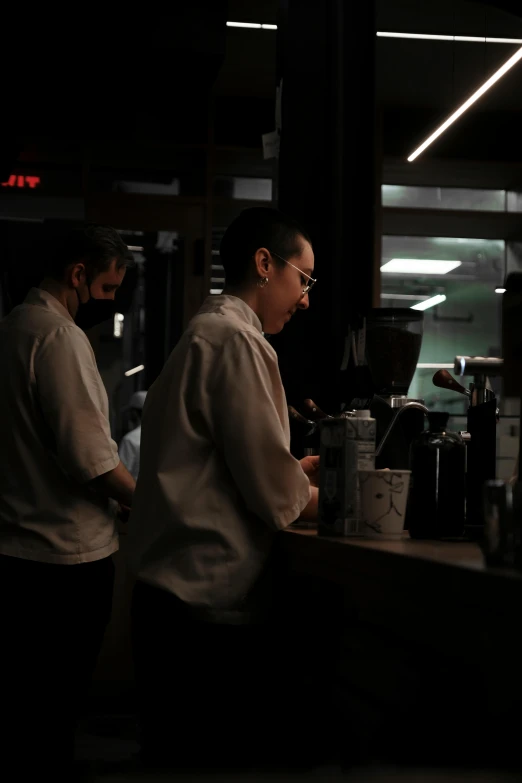 a man and woman standing behind a bar in a restaurant