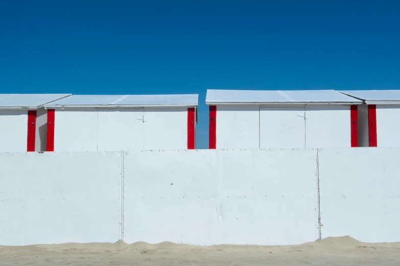 a long red and white wall and some windows