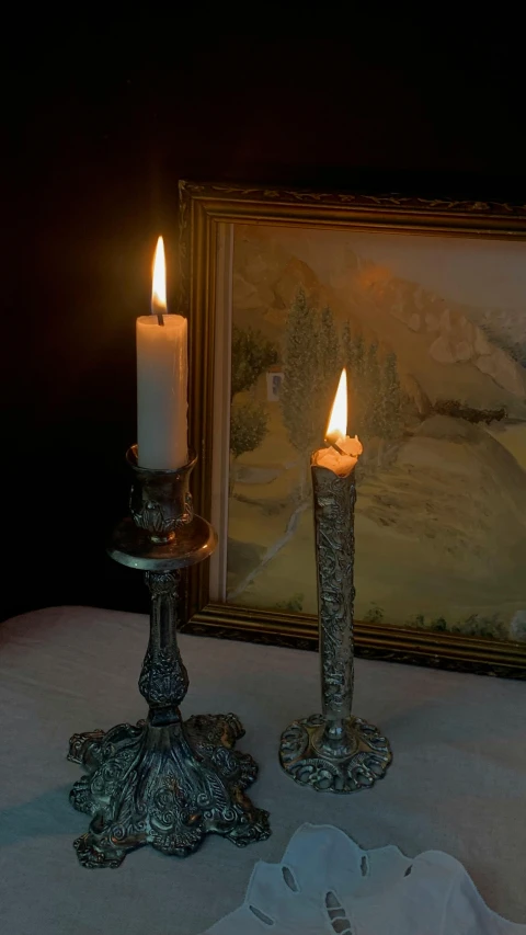 a picture of a lit candle in front of a mirror