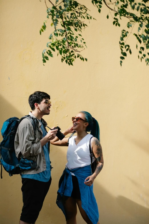 a man talking to another person with a backpack on