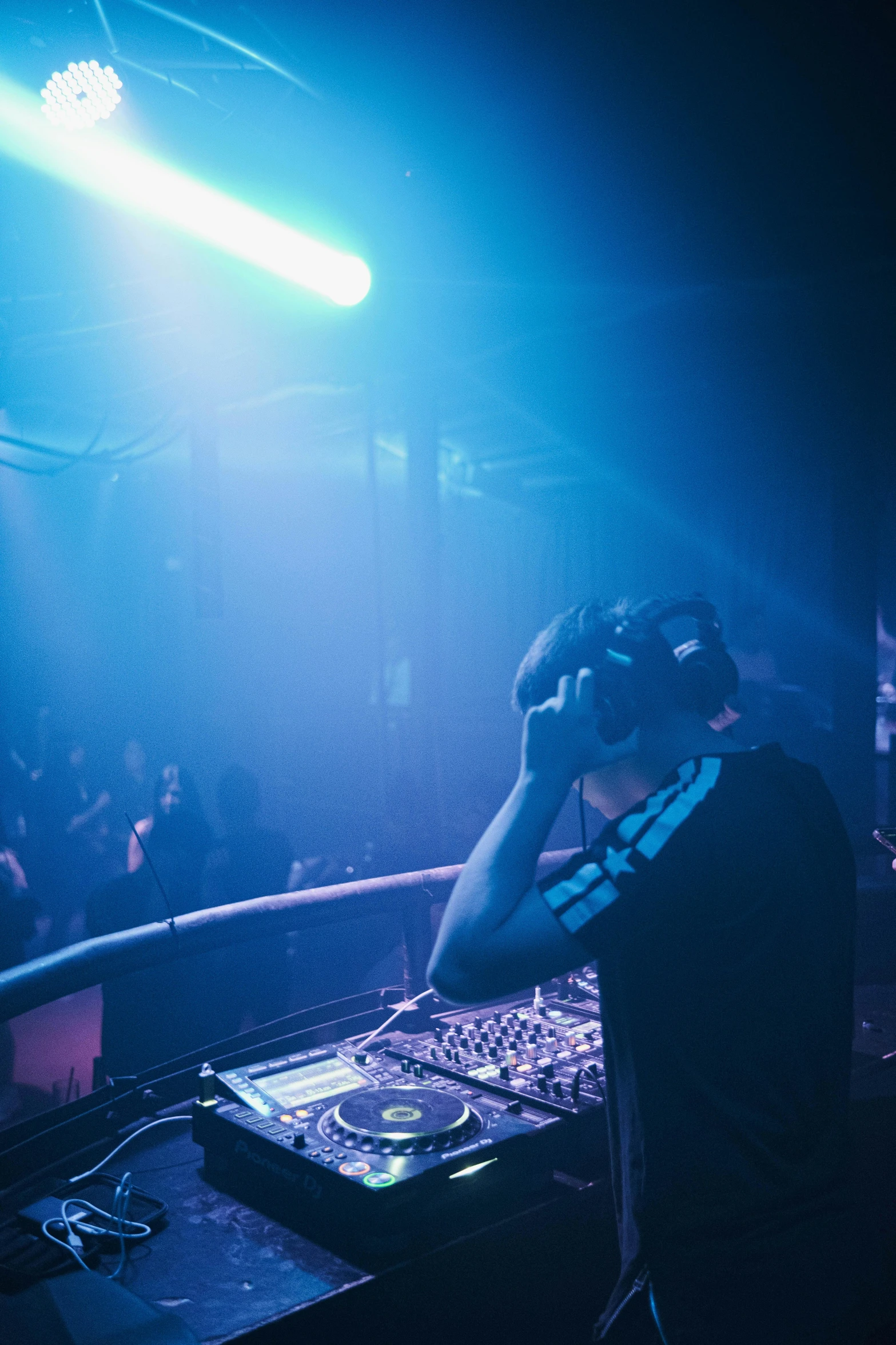 a dj standing in front of a mixer