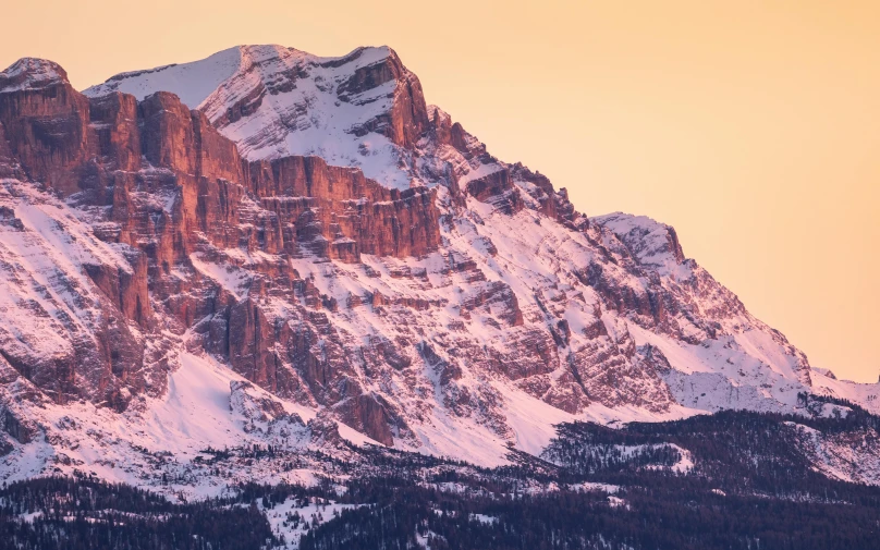 snow covered mountain peaks rise high above the snow capped terrain