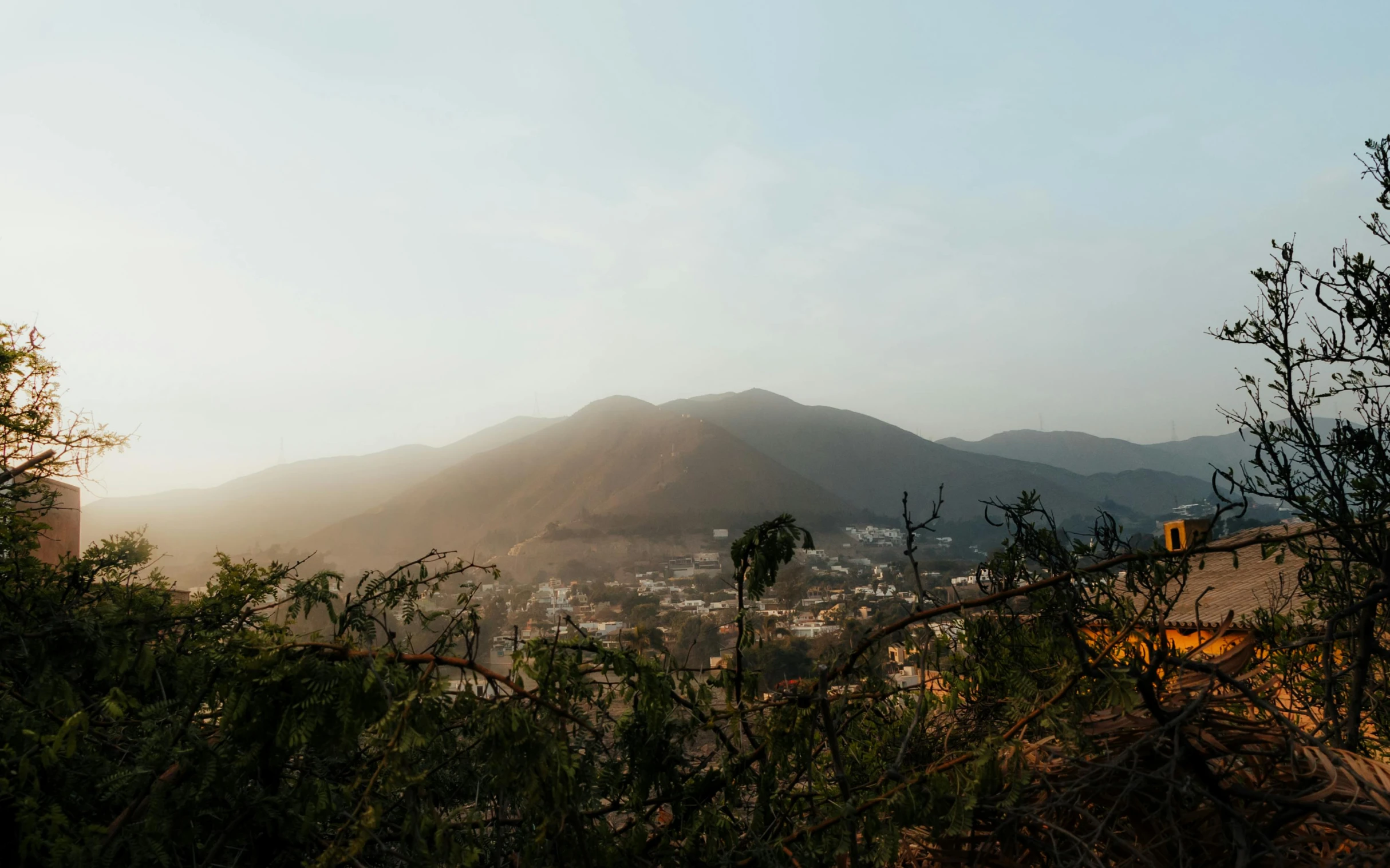 a view of a mountain area with buildings and trees