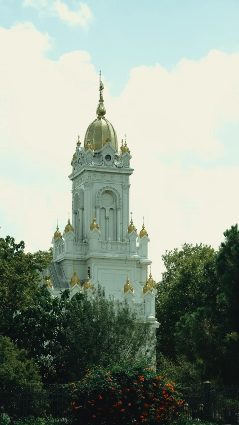 a view of a large white building with gold domes