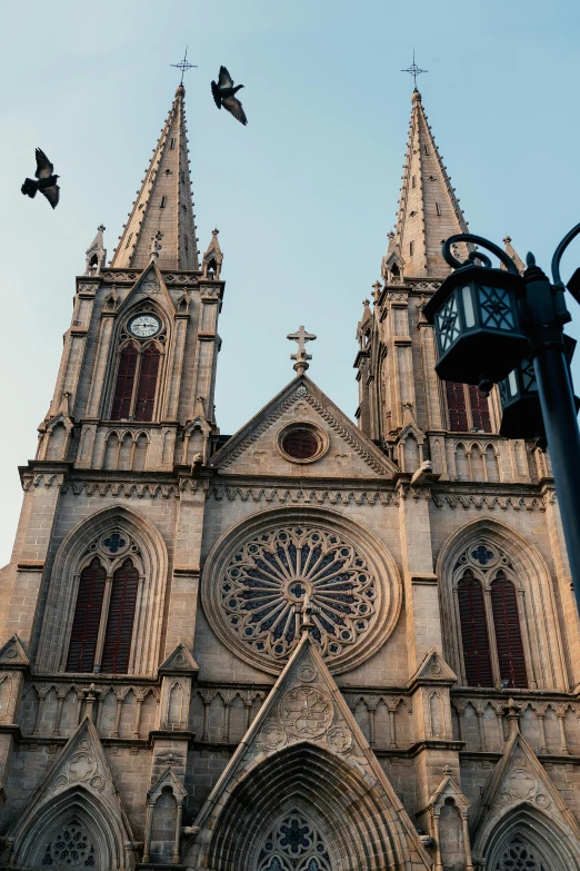 the facade of a large cathedral with clocks on it