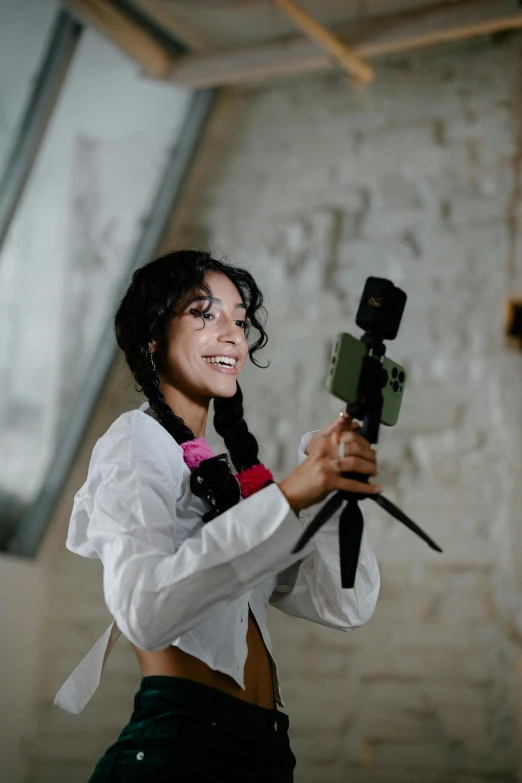 a woman with a camera posing in an old room