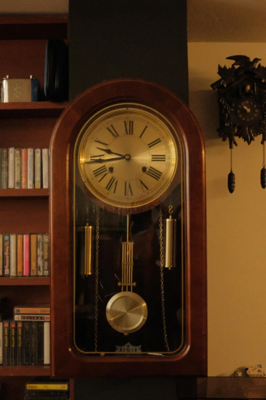 an old clock with roman numerals in a living room