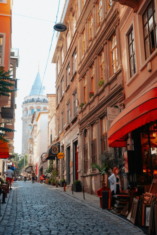 a cobblestone street with shops on both sides