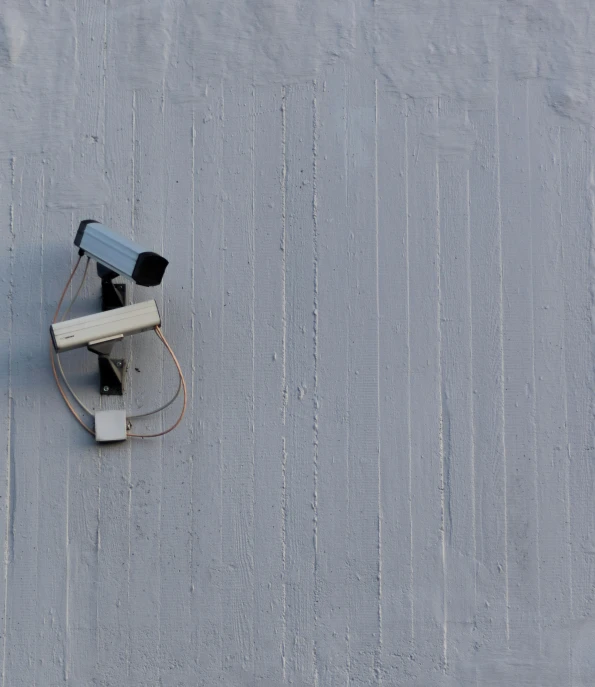 the security cameras are attached to the wall