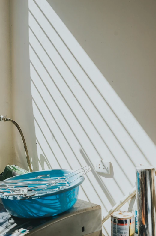 a blue bowl in the corner of a room