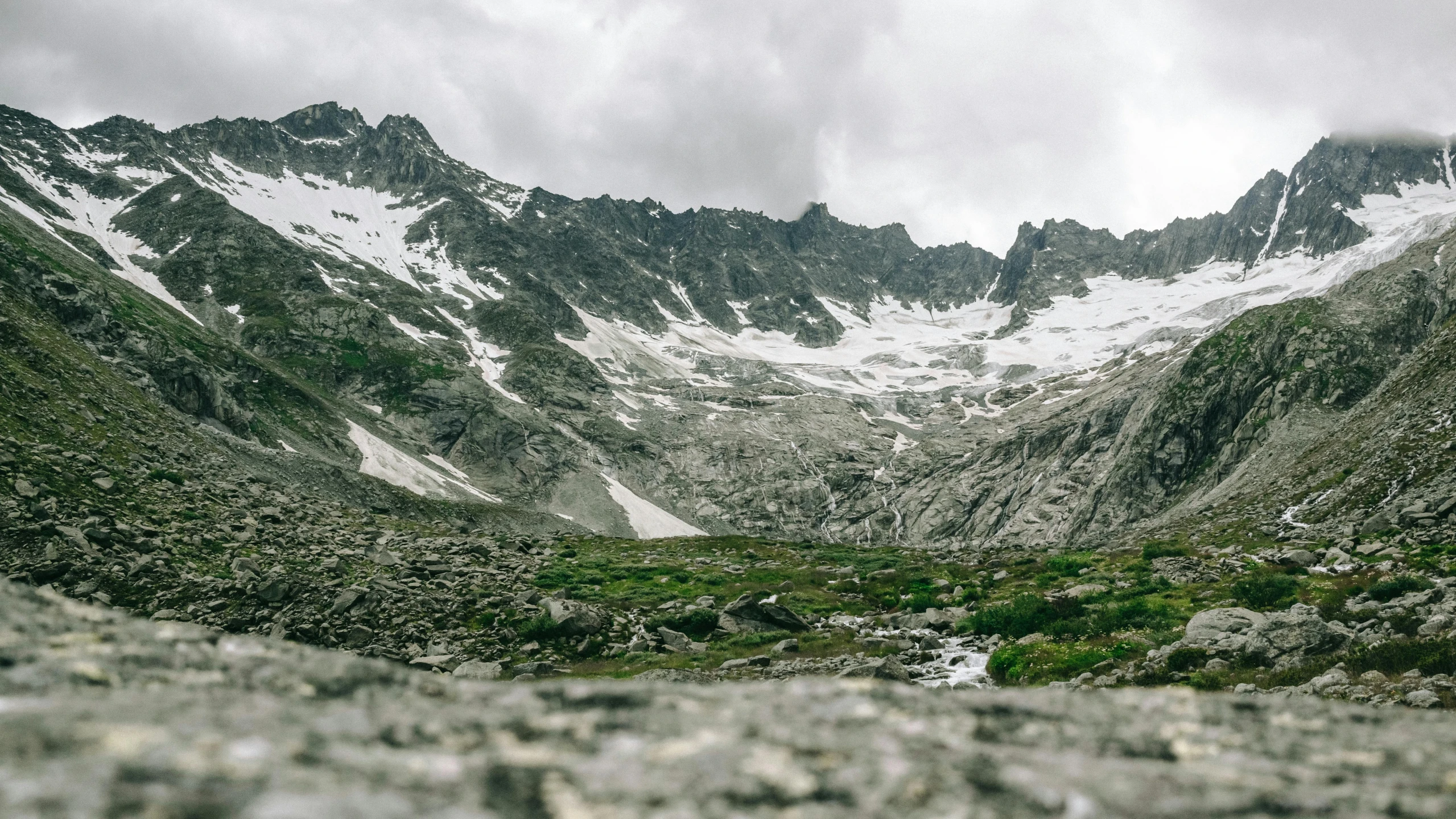 a wide po of some mountains under a cloudy sky