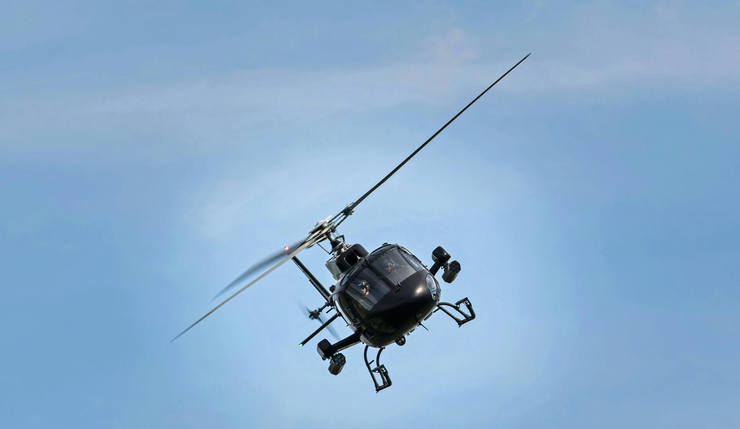 a helicopter flying through the air with the handle extended