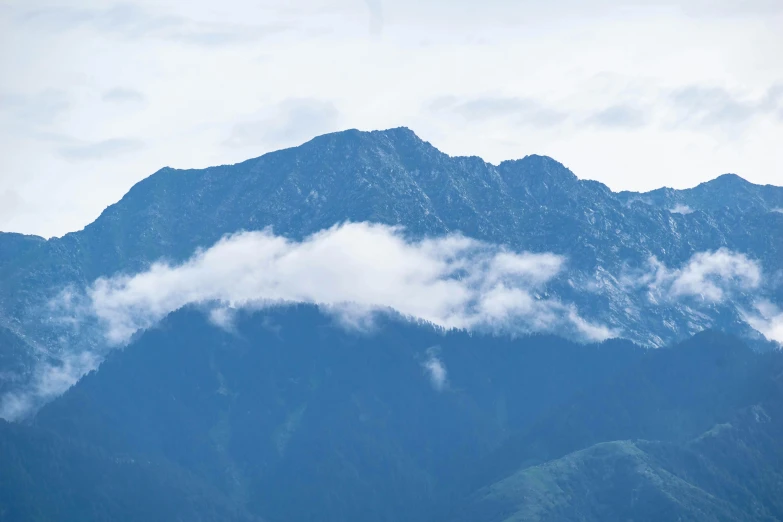 there is a plane flying over the mountains