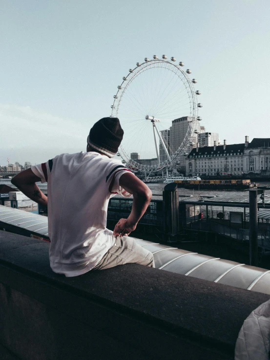 a man is looking at the city in a ferris wheel