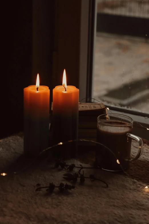 three lit candles sitting on top of a brown carpet