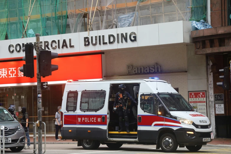 the police van is pulled up to a building