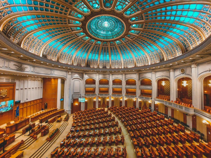 a circular room with two sets of chairs and blue dome