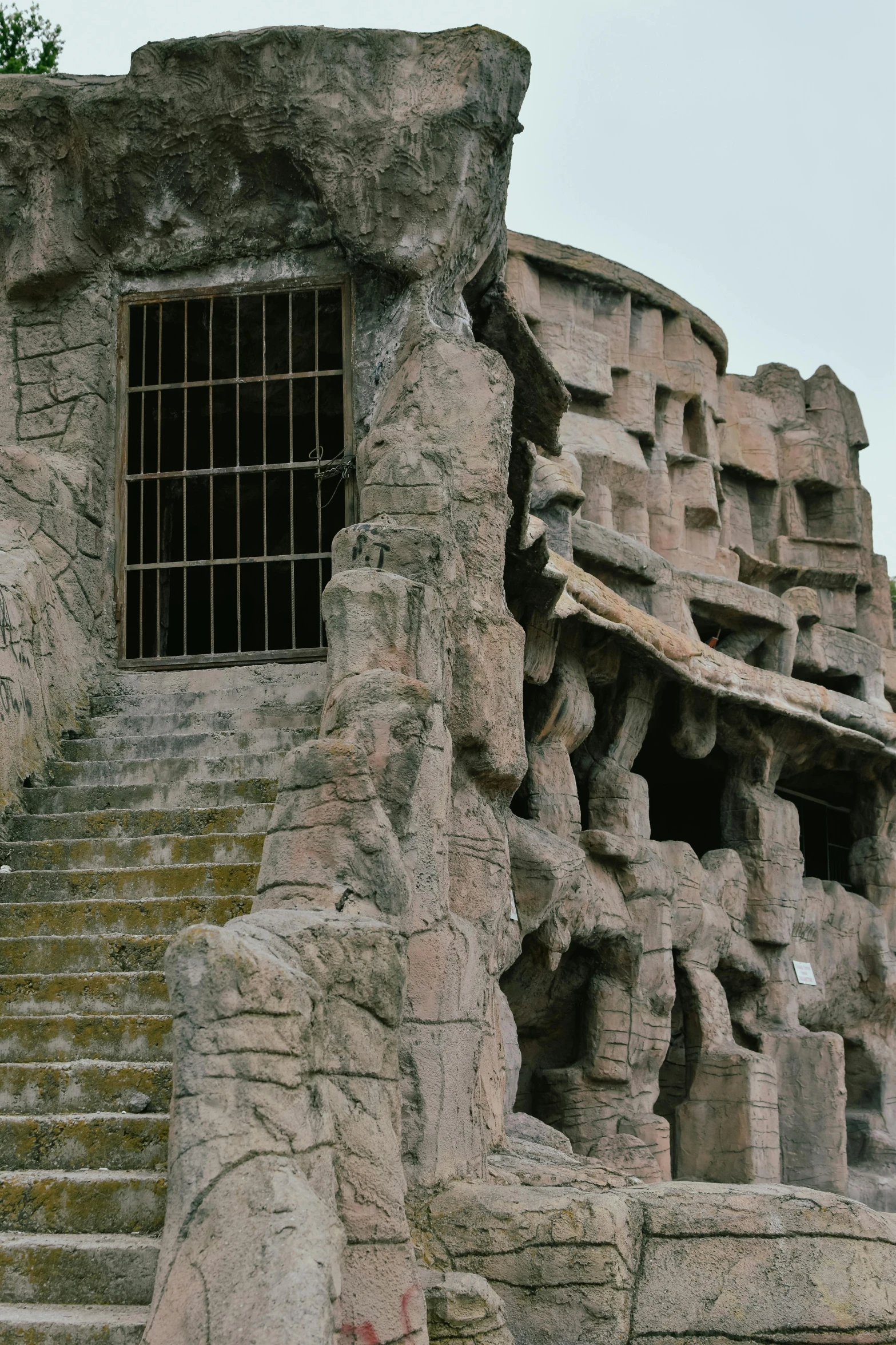 a building made of stone with a window and staircase