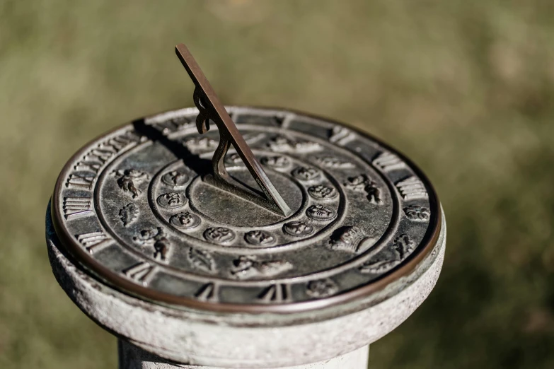 a metal clock on top of a street pole