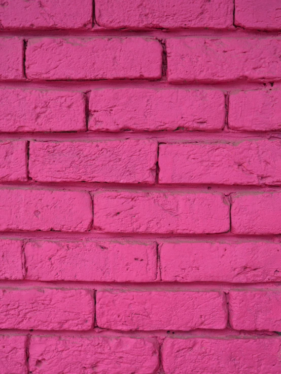 a close up of a brick wall in a pink color