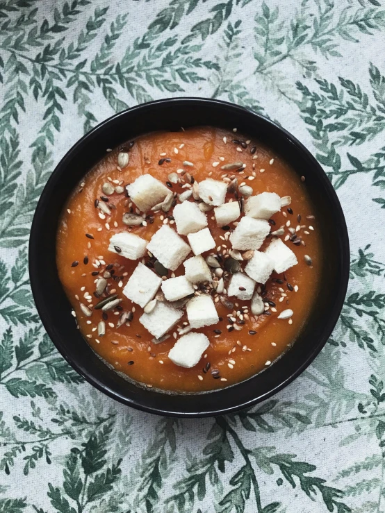 a bowl filled with lots of food on top of a table