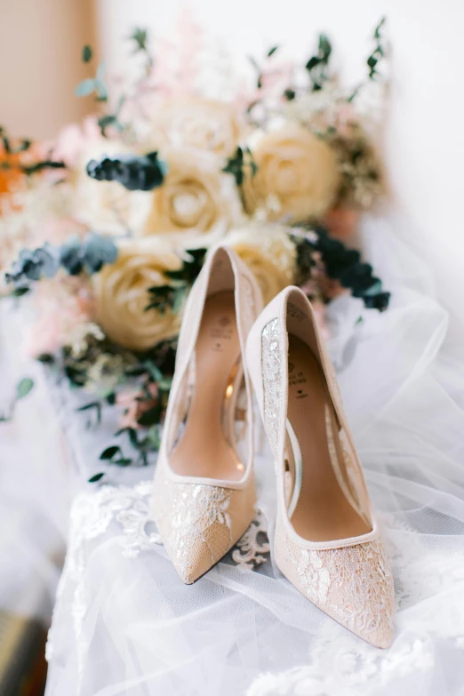 a bride's shoes sitting on the bed