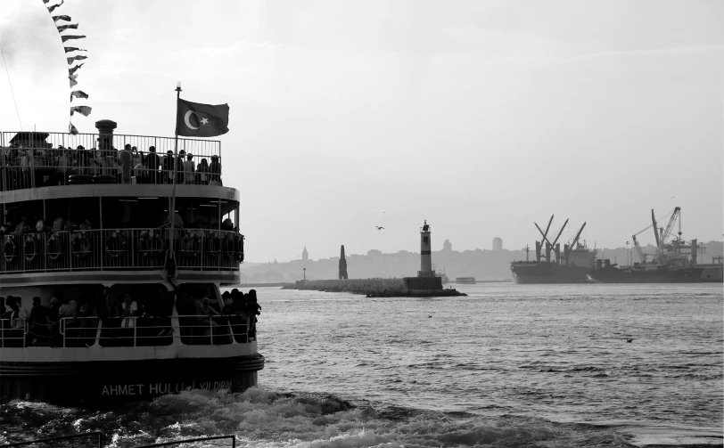 the back of a ferry carrying passengers down a river