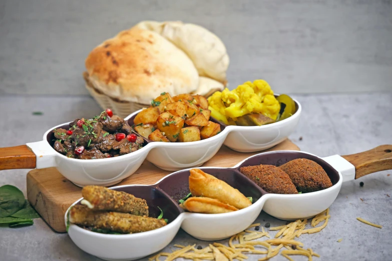 a number of bowls on a table with food