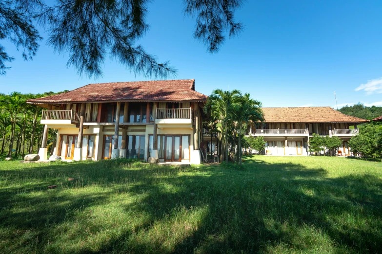 a view of two houses from across the yard