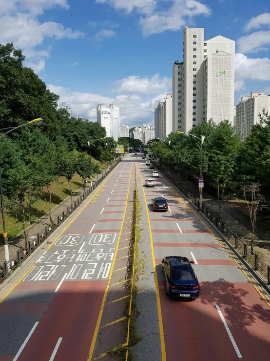 a car driving down a city street with tall buildings