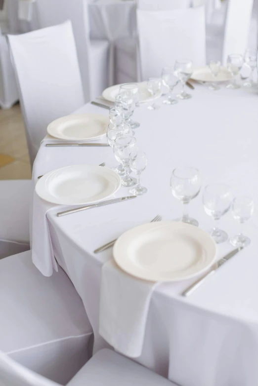 a table set up with many empty plates