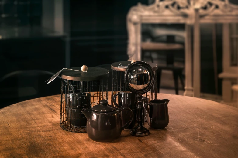 a small group of coffee pot sitting on top of a wooden table