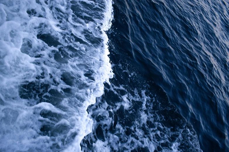 a surfer on a surfboard is coming towards a wave