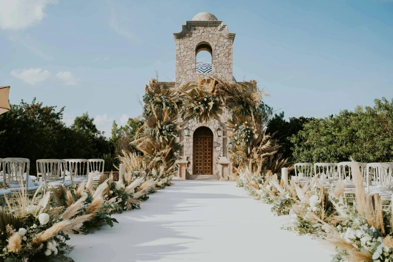 this church has an archway that leads to a large clock tower