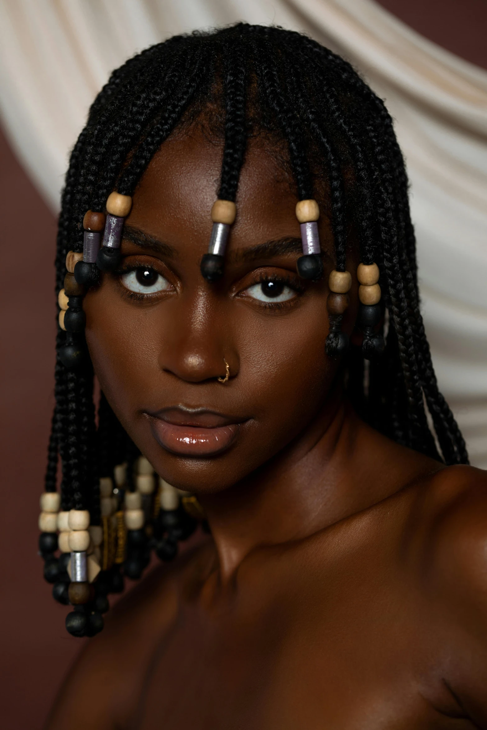 a black woman with dreadlocks and large earrings on her head