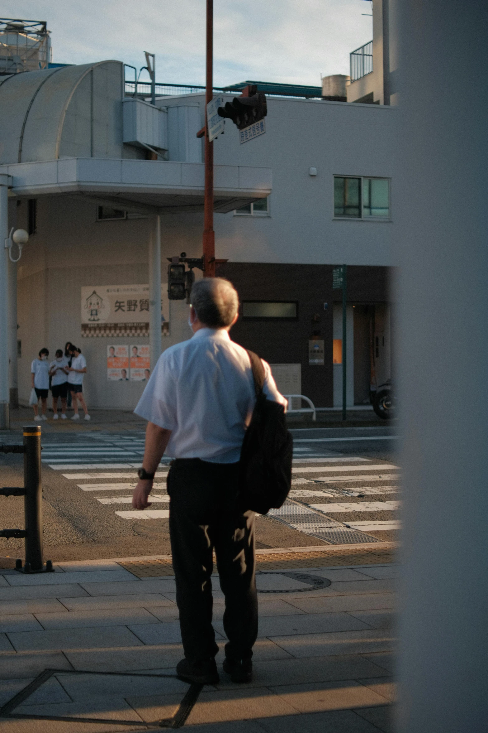 the man is carrying a backpack down the street