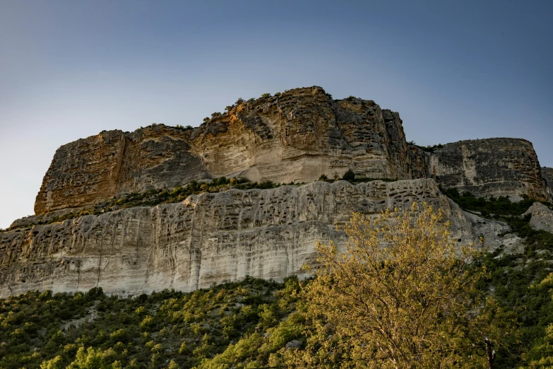 an unusual formation of rocks with trees in foreground