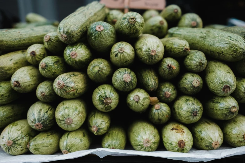 several piles of cucumbers stacked on top of each other