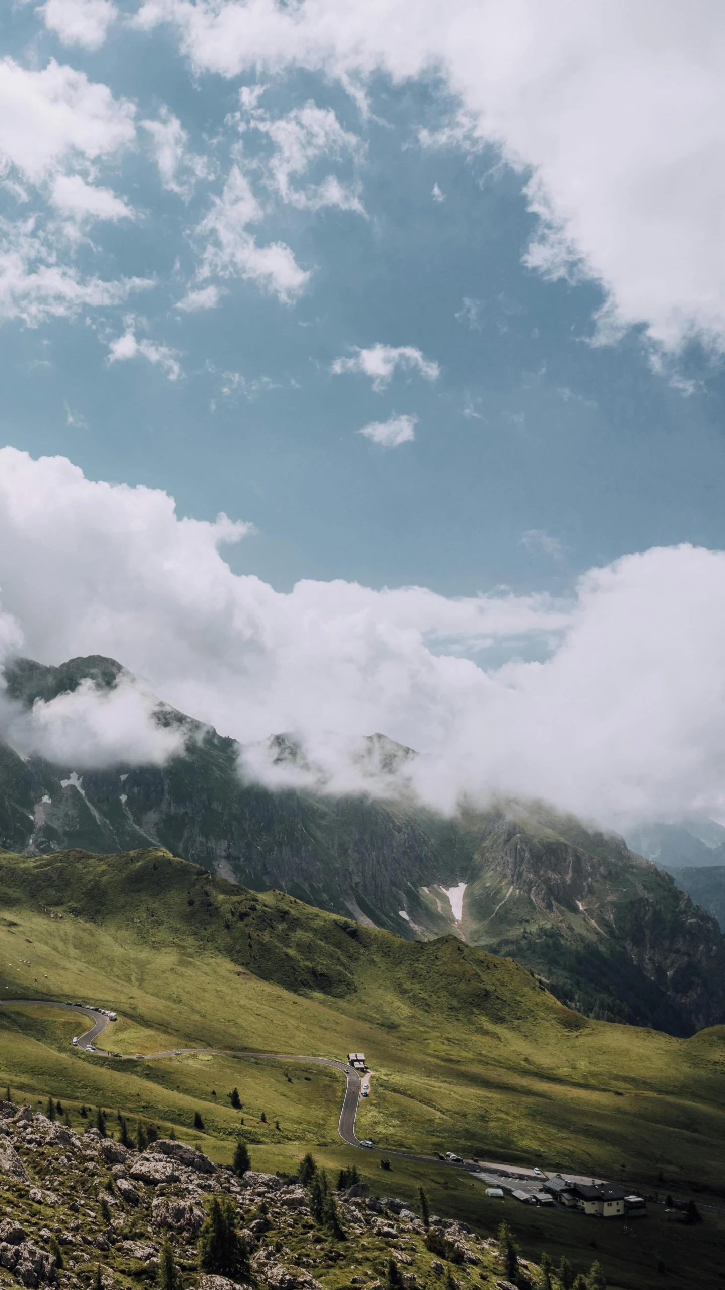 the scenic view of a mountain range and valley under clouds