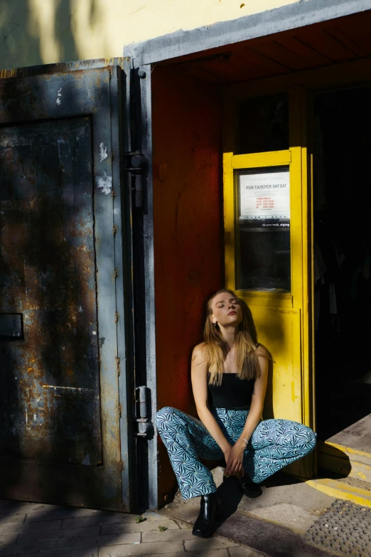 a woman sitting in a doorway of an old building