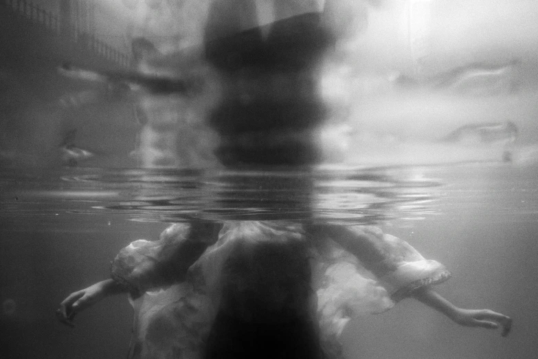 people swimming near the surface of water with a blurry background