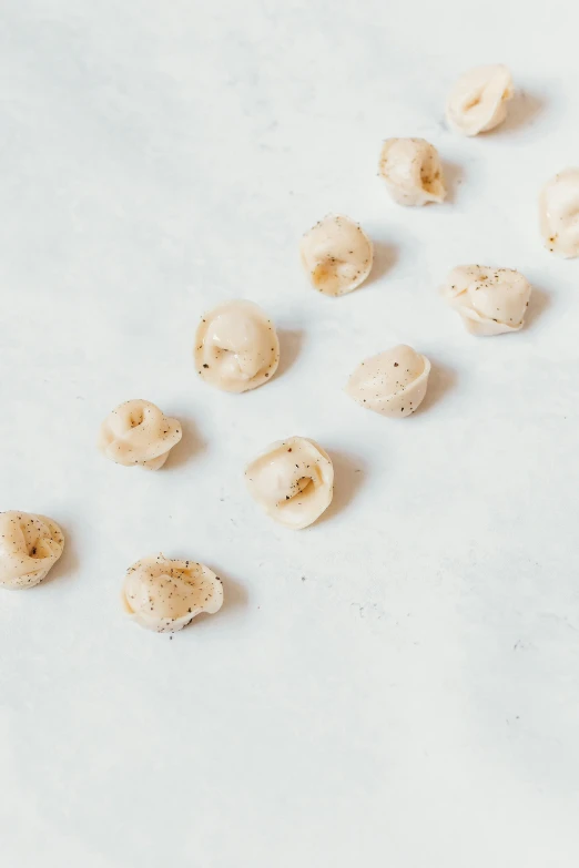 peeled cashews on white background with plenty of peel