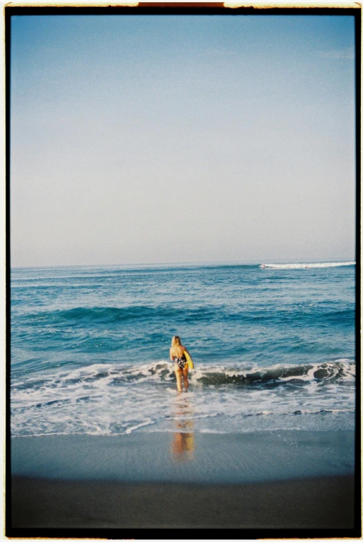 a person standing on top of a beach near the ocean