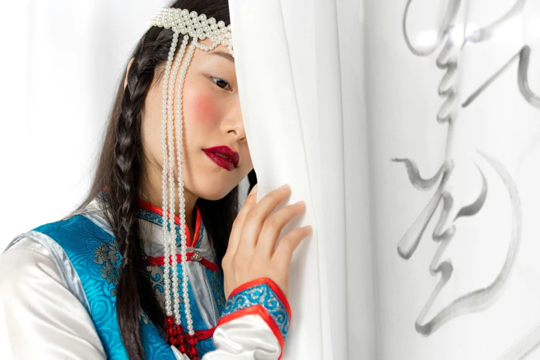 woman with a long haircut wearing oriental clothing and jewelry