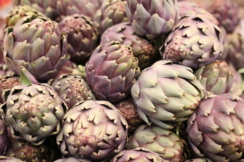 an arrangement of artichokes displayed on a tray