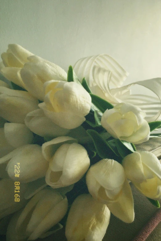 a bouquet of white flowers on a brown pillow