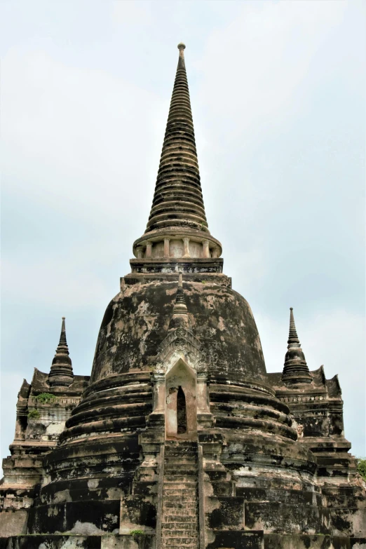 a large temple sits atop a rocky terrain