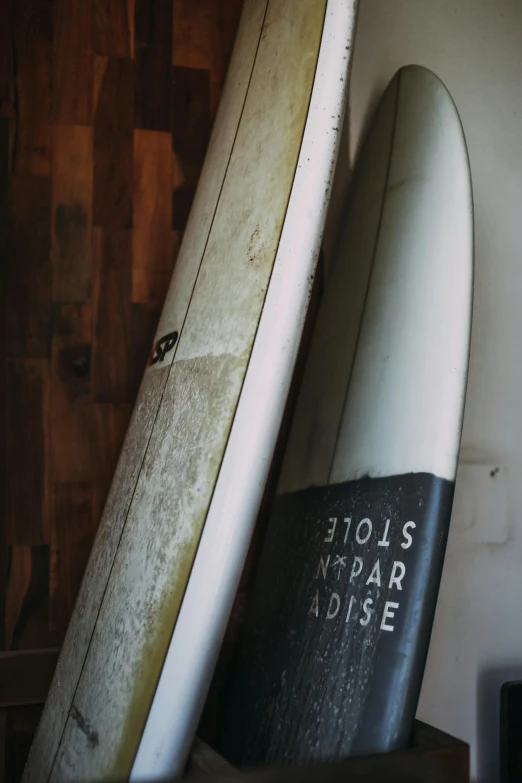 there is an old book sitting on top of two surfboards