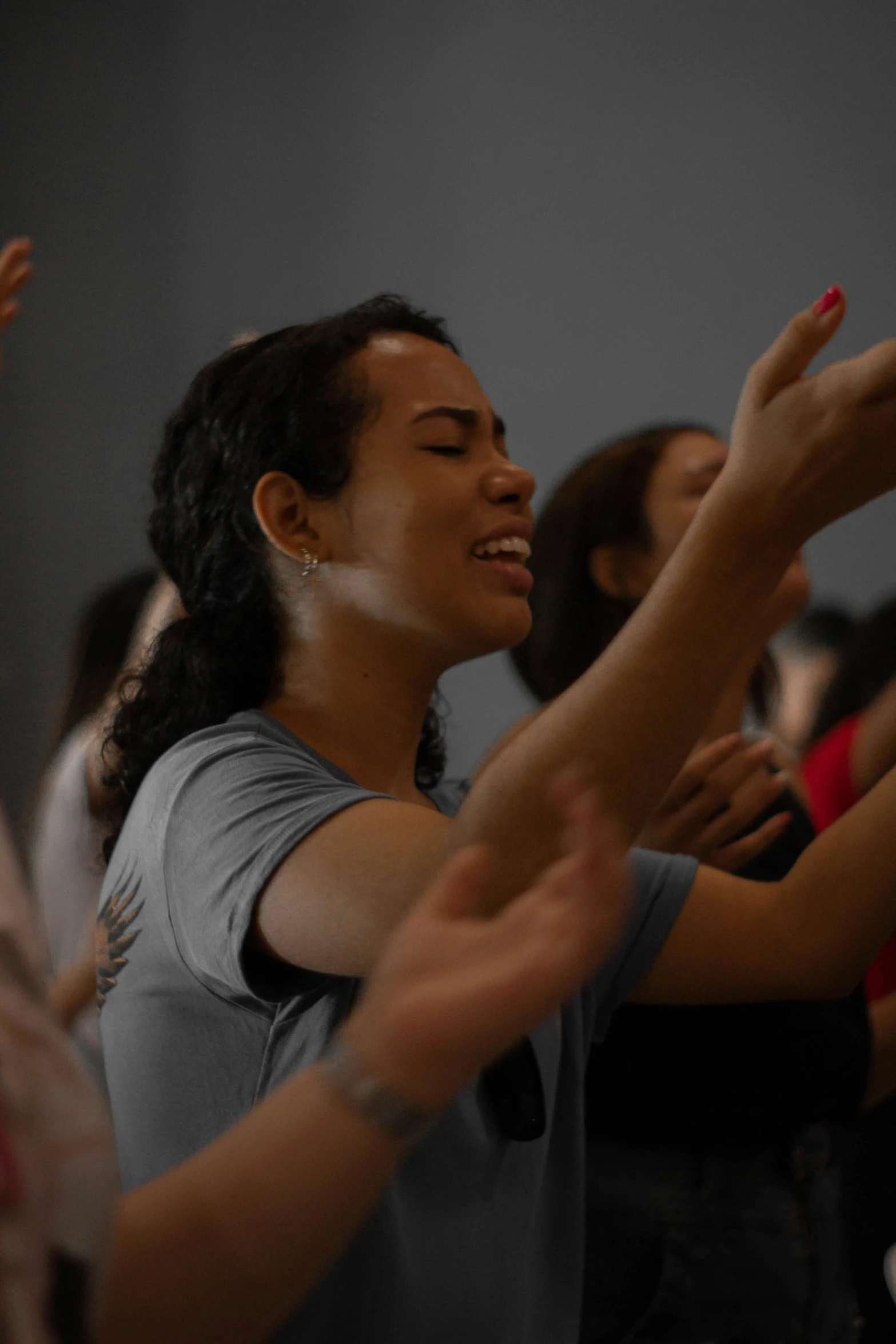 a woman dancing with others clapping behind her